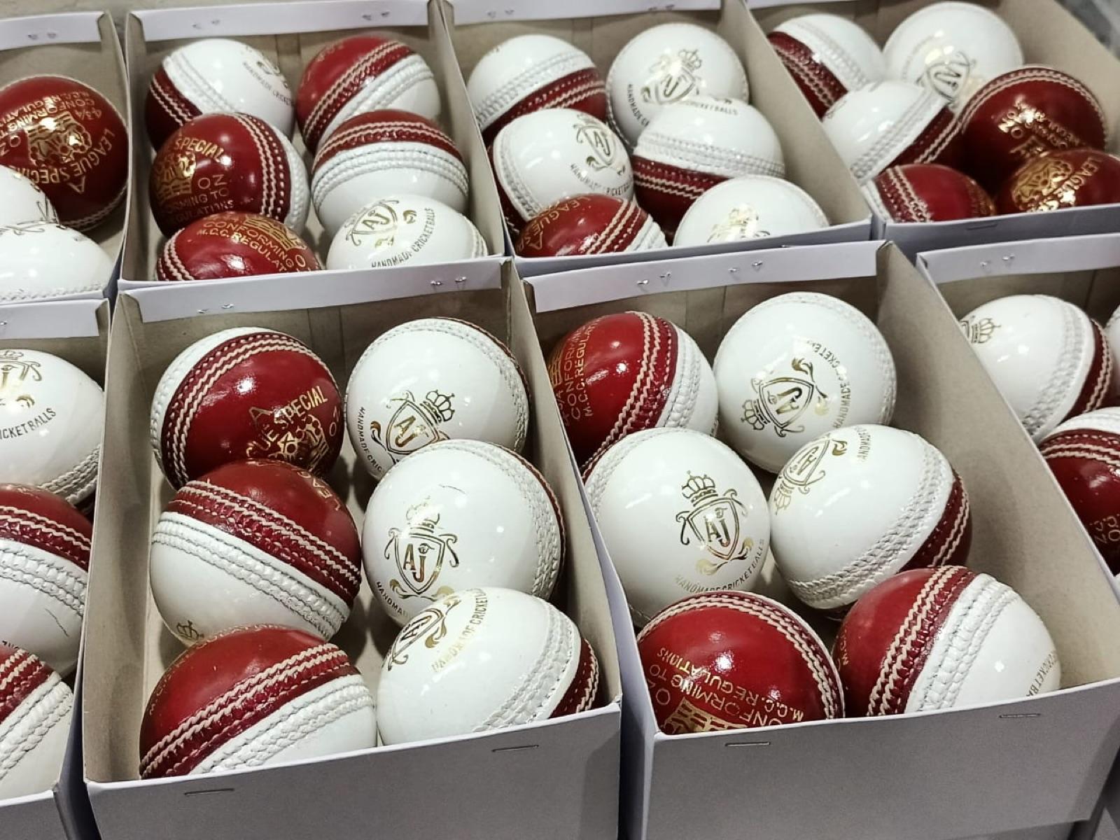 Red and white AJ cricket balls boxed and ready to ship